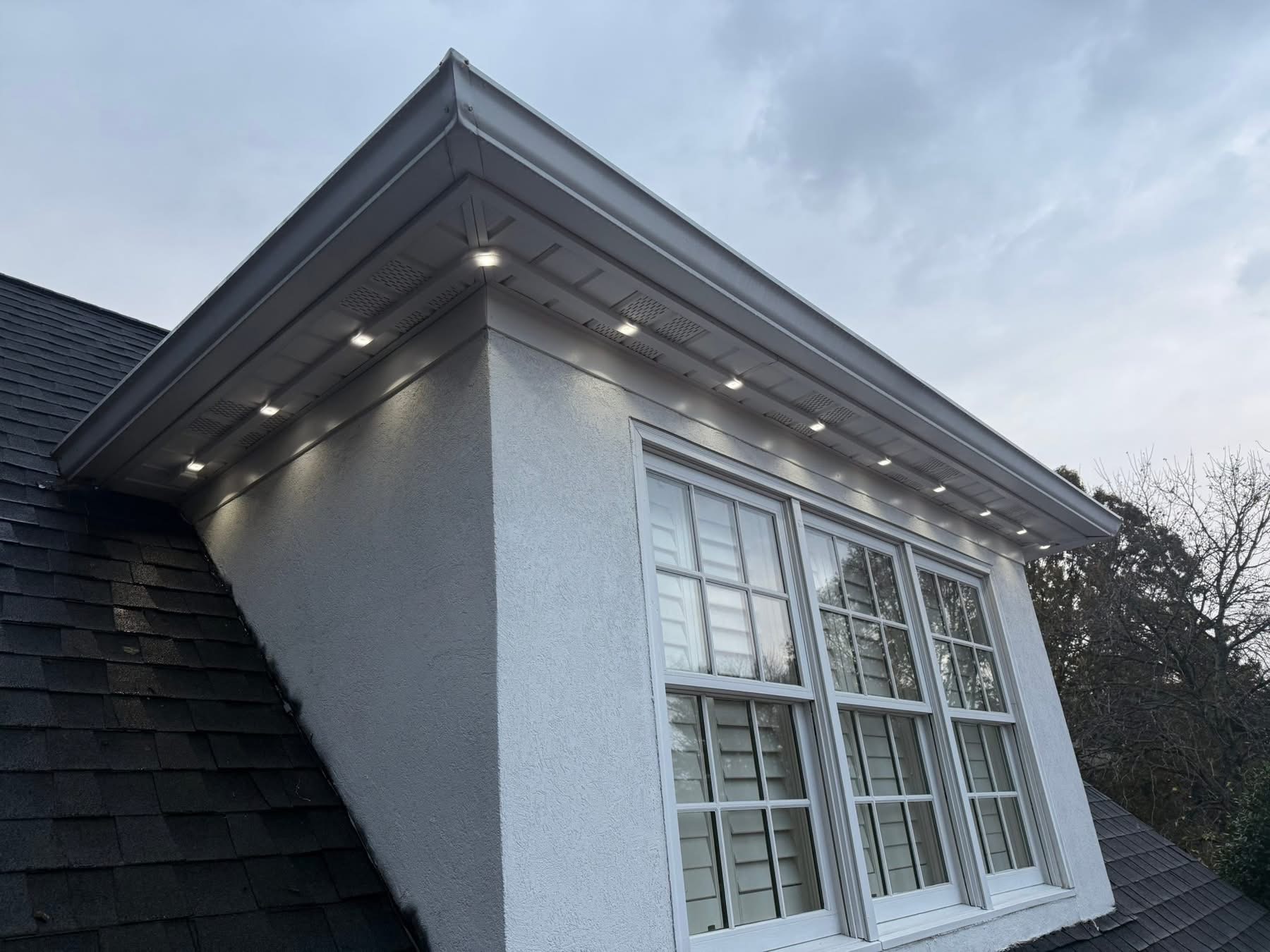 Close-up of hidden permanent lighting track installed under the roofline